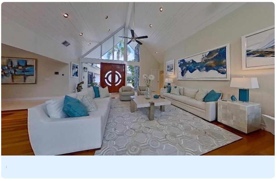 Modern 3D virtual tour interface showing multiple views of a bright contemporary home interior with white and blue decor elements.
