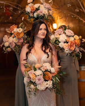 Wedding dress details featuring coral and lavender floral arrangements with delicate lace and romantic lighting effects.