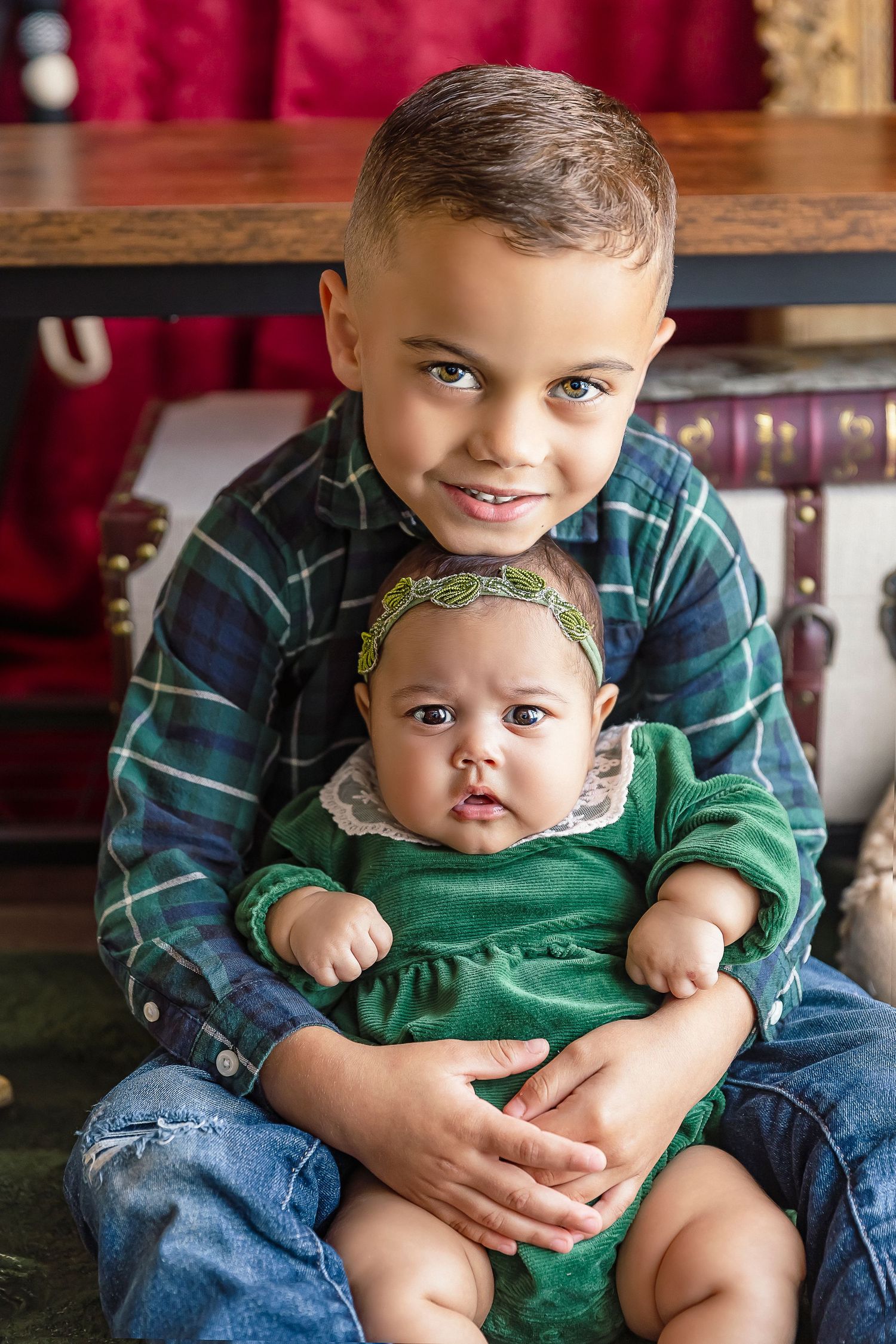 siblings big brother holds baby sister