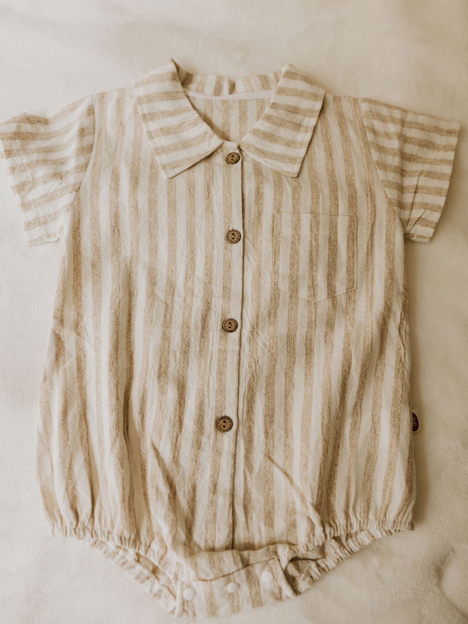 Adorable vintage-inspired baby boy outfit with white button-down shirt, blue striped suspender shorts and matching bowtie.
