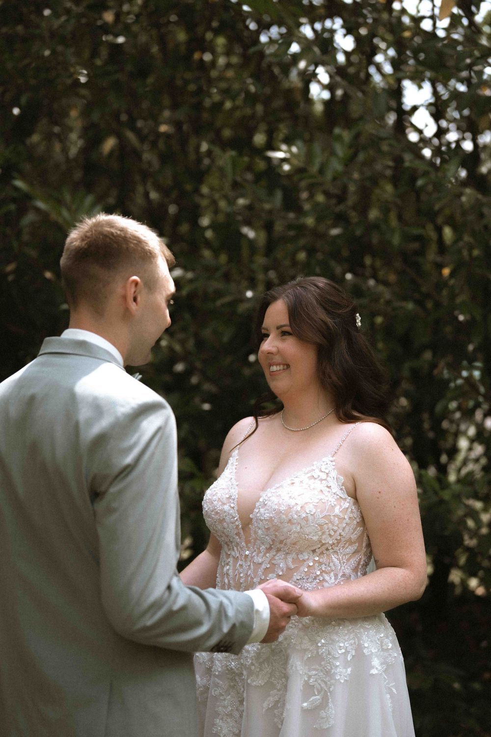 Couple shares their first look moment in an intimate outdoor wedding setting.