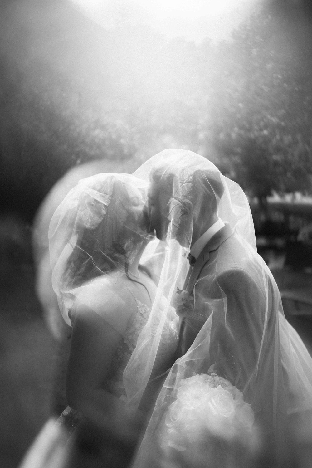 Dreamy black and white portraits show flowing wedding veil movement.