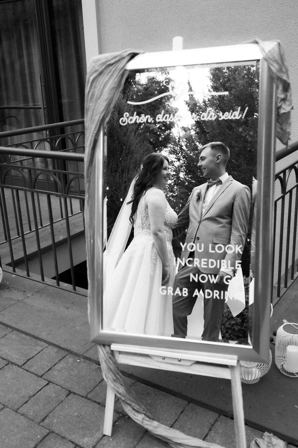 A black and white photo of a couple reflected in a mirror with text overlay.
