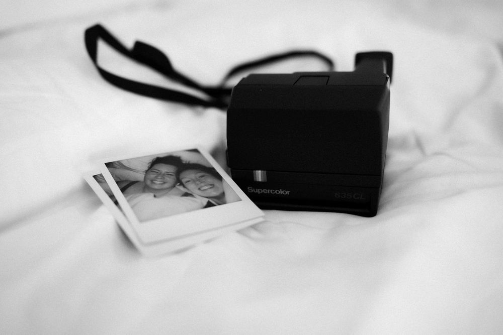 Silhouettes of personal items arranged on a white surface.
