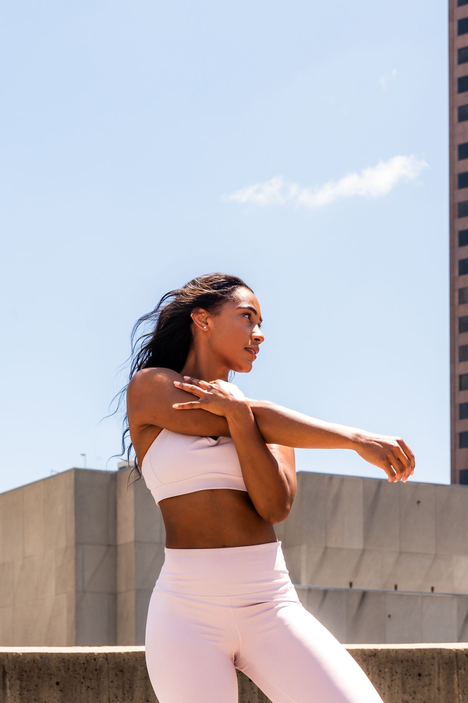 Dynamic sequence showing athletic movement against a bright blue sky and concrete wall background.