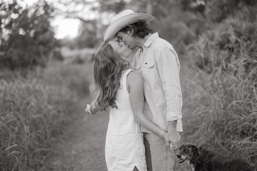 Series of candid romantic moments captured in black and white showing couple embracing outdoors.