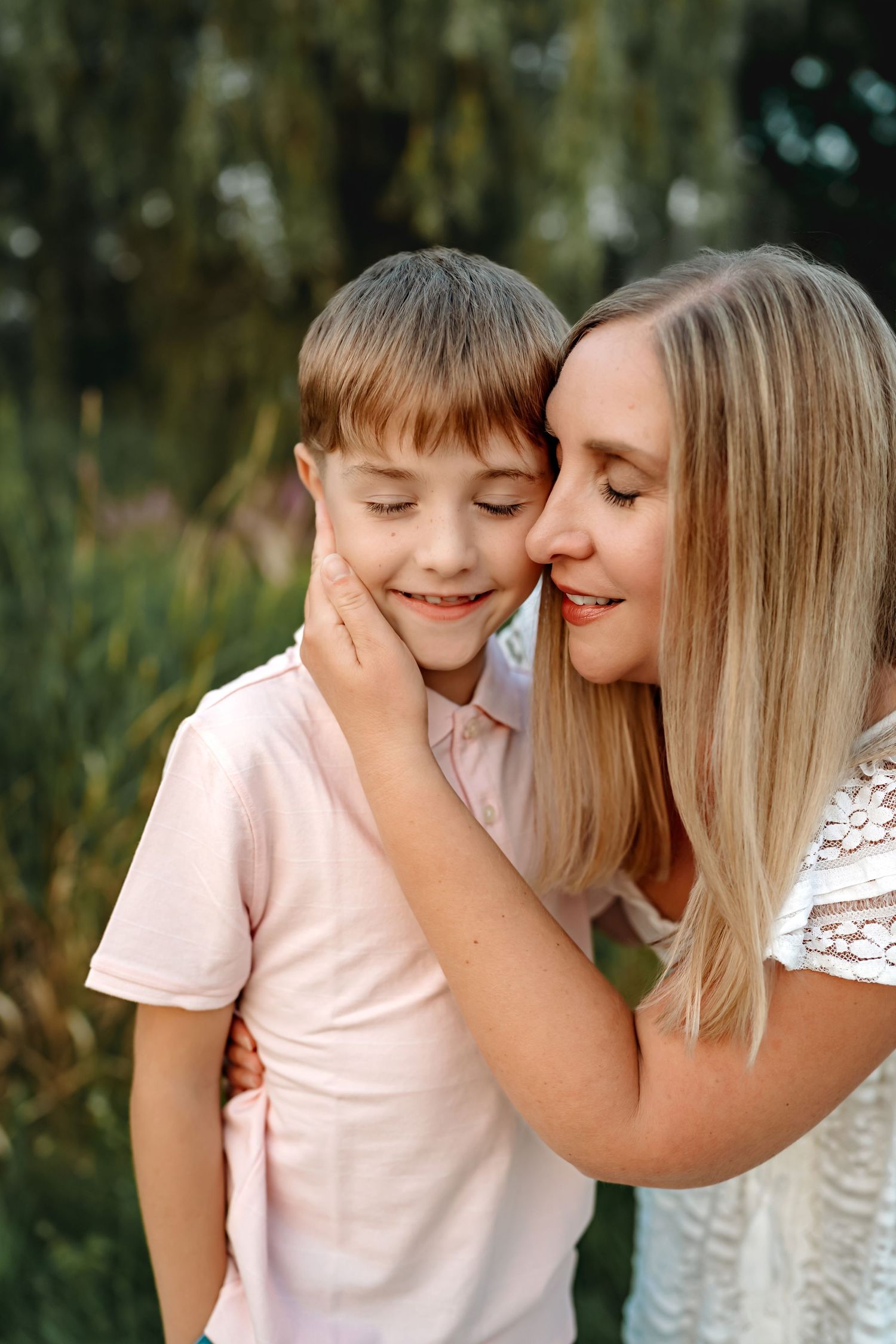 A touching moment of warmth and connection captured in an outdoor garden setting with soft natural lighting.
