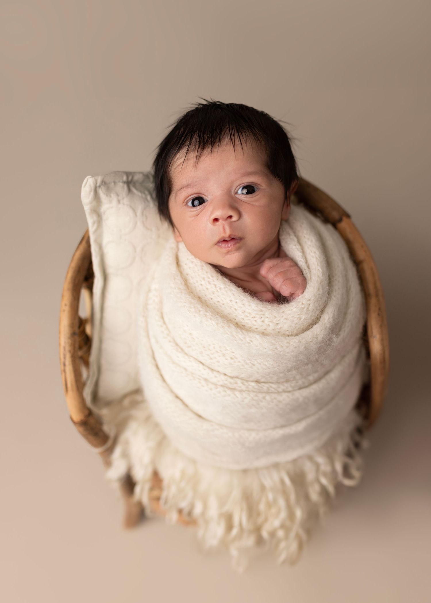 Wide awake baby boy, Wrapped up in the bamboo newborn chair.
