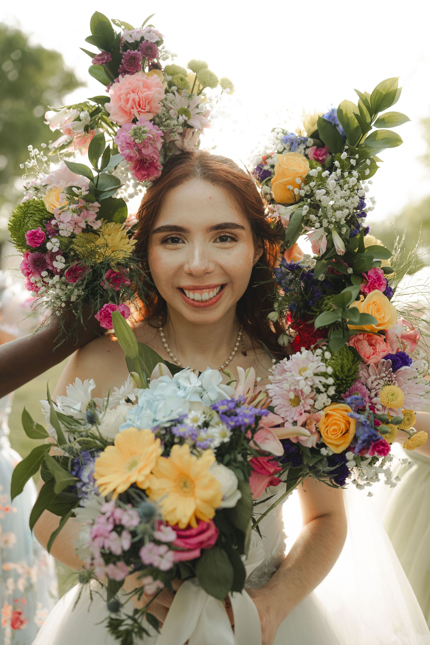 Vibrant floral crowns with colorful blooms and greenery create a whimsical wedding detail.