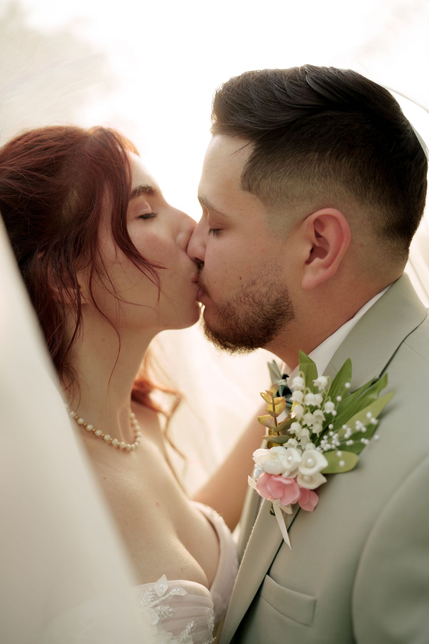 Romantic wedding portrait series showing tender moments between newlyweds in soft lighting.