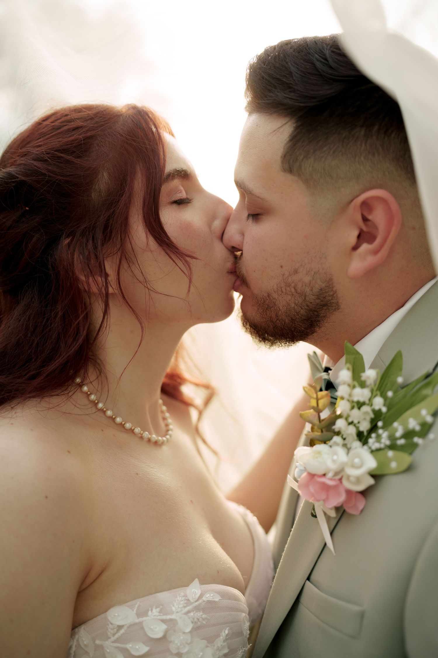Intimate wedding photography sequence captures couple's romantic kiss in golden light.