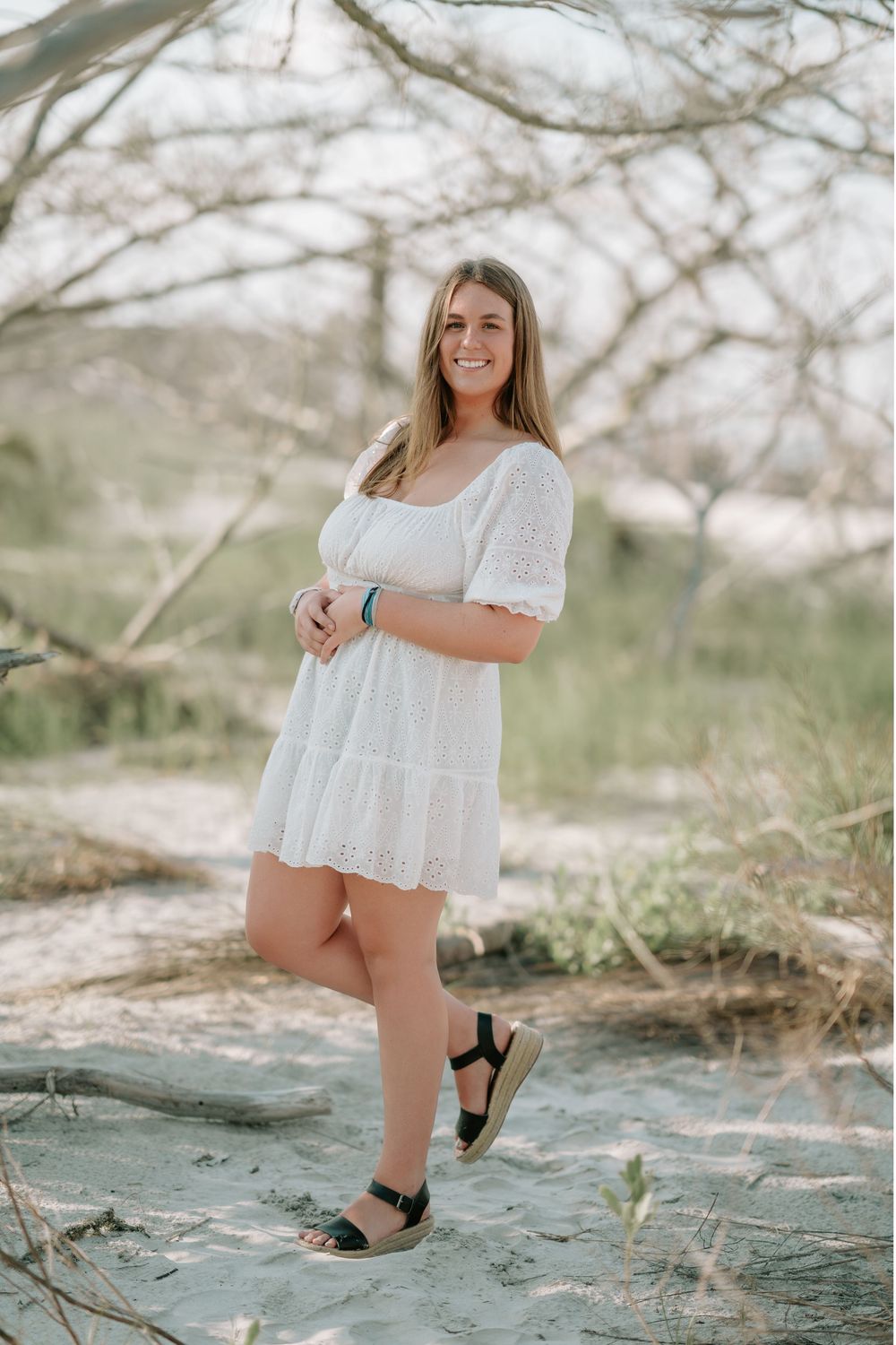 Senior photo session on Jekyll Island with ocean waves, driftwood, and warm Golden Isles sunset lighting by Lindy Rebro Photography.