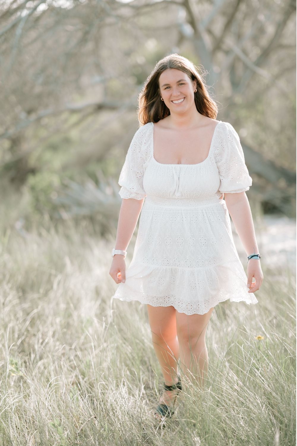 Golden Isles senior photography at Jekyll Island’s Driftwood Beach with ocean views and textured driftwood trees.