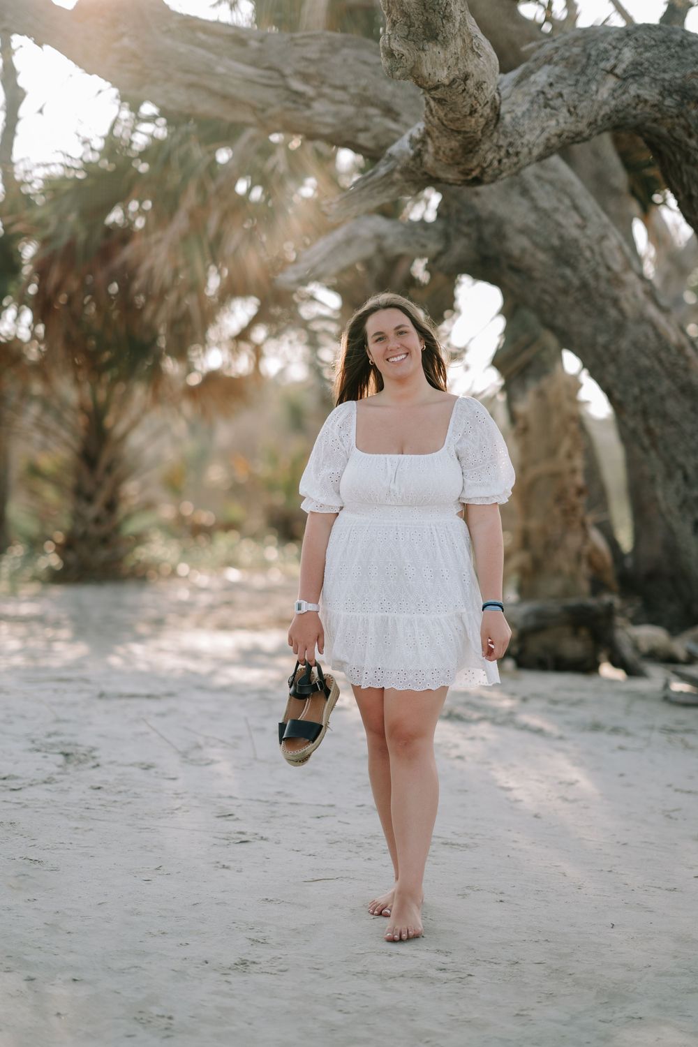 Senior girl portrait with long dress at Jekyll Island’s driftwood shoreline, photographed in coastal Georgia by Lindy Rebro.