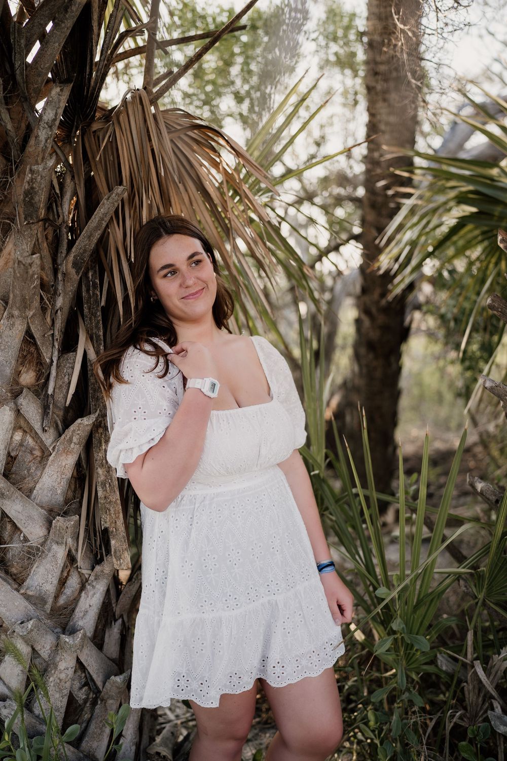 Golden Isles high school senior photography at Jekyll Island, with ocean waves and driftwood in the background.