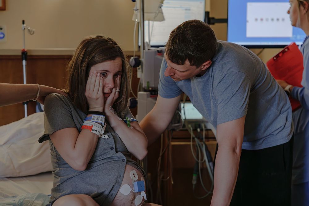 Medical staff monitoring patient vitals in hospital room.
