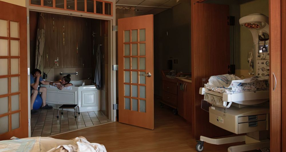 Interior view of a medical facility with wooden paneling and glass doors.