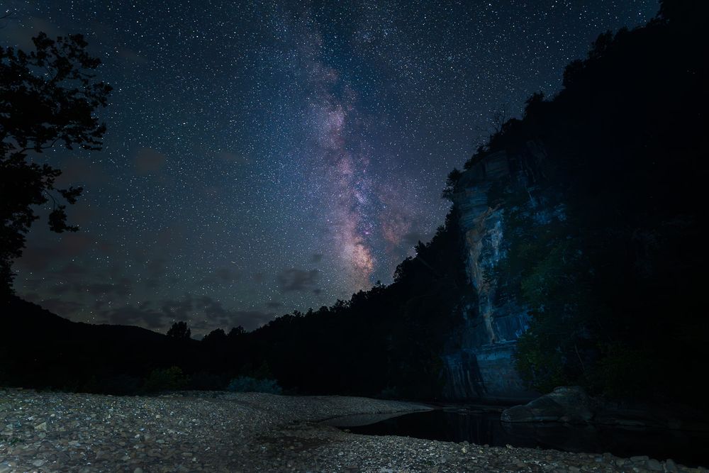 Milky Way galaxy visible over a rocky river canyon under a stunning starry night sky. Steel Creek Buffalo National River