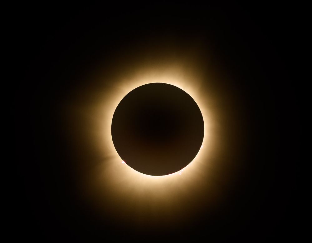 A stunning total solar eclipse reveals the sun's glowing corona around the dark silhouette of the moon. Winona Missouri 2024
