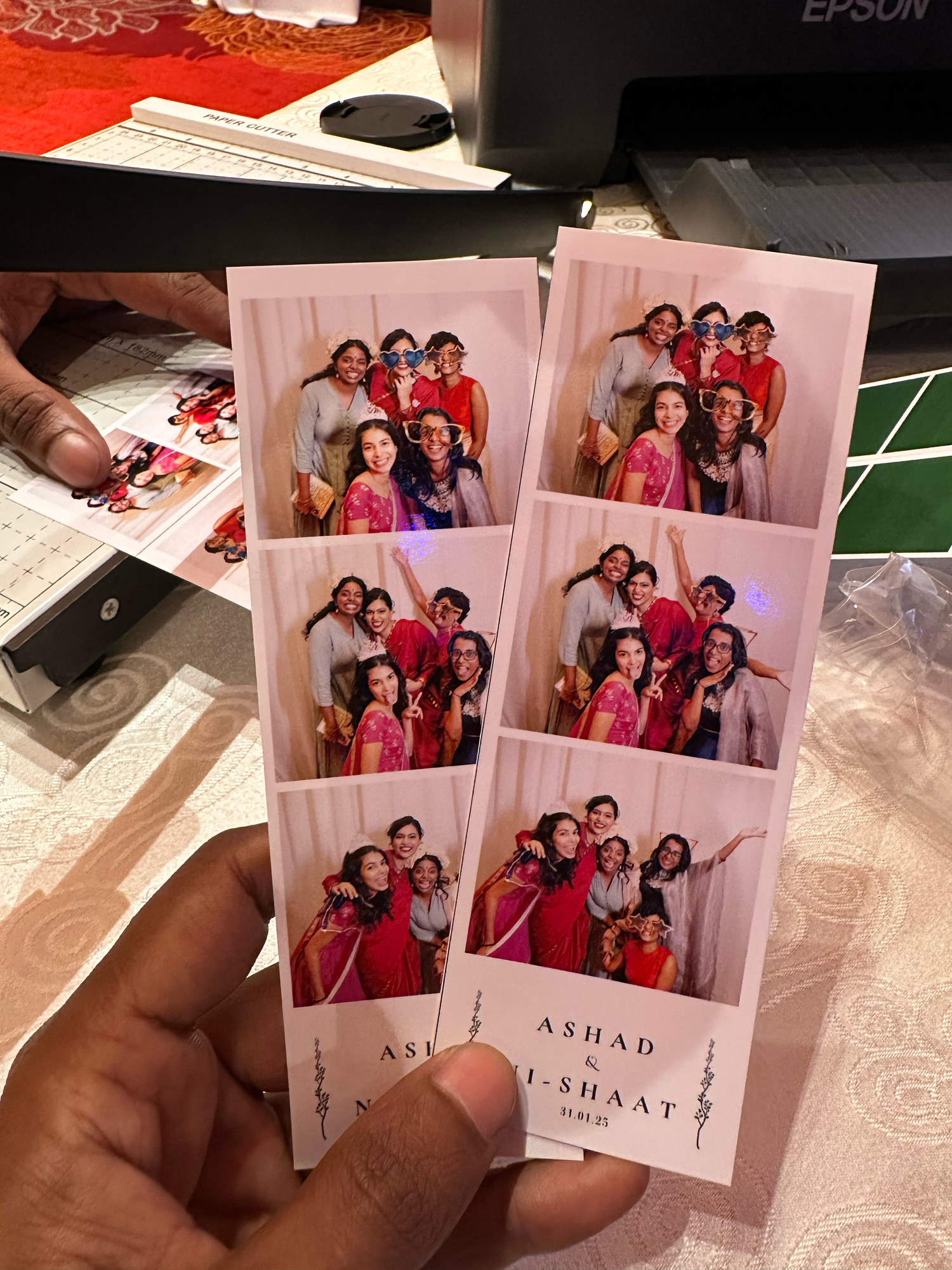 Multiple photo prints from a wedding celebration displayed with matching red tones.