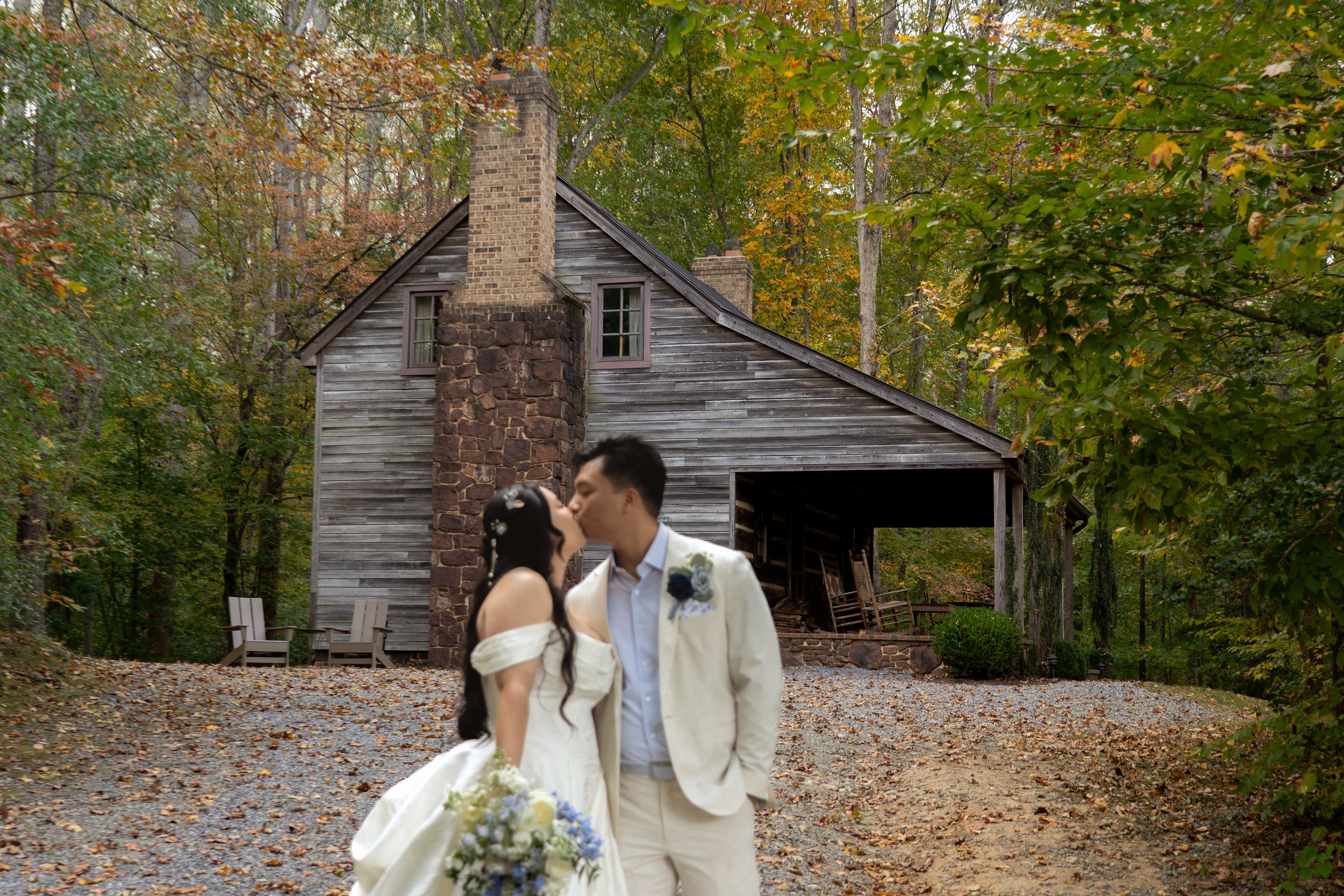 Editorial Image of asian wedding couple kissing with trees behind them