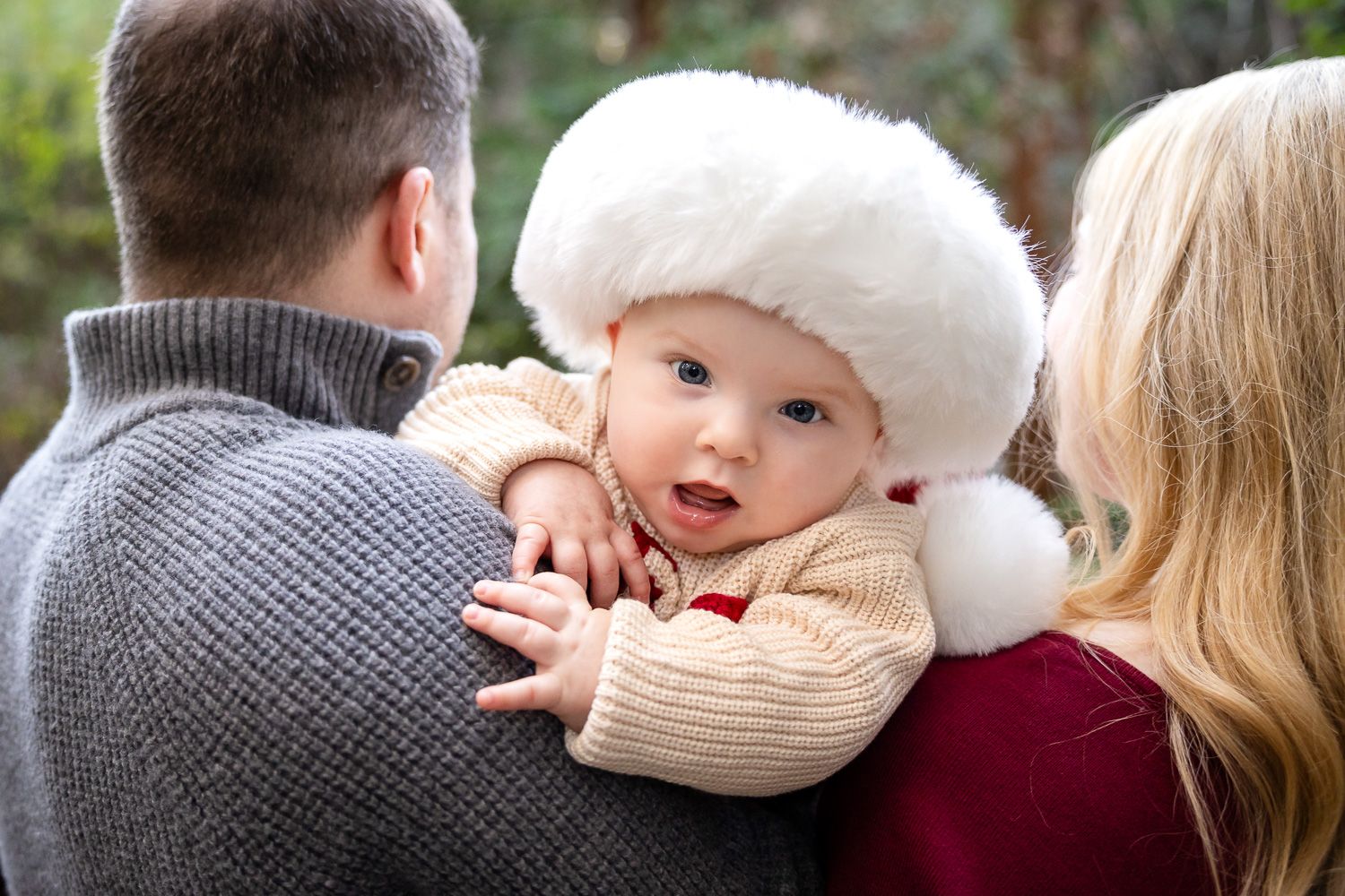 Close up photo of Bay Area family embracing and sharing tender moments together outdoors.