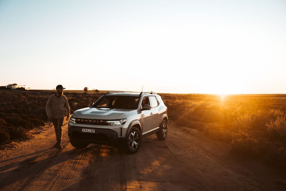Automotive lifestyle photography featuring Renault Duster road trip through remote Australian outback at sunset