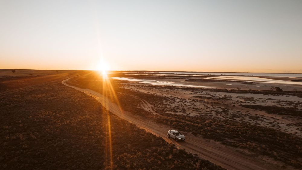Automotive adventure photography featuring Renault Duster driving through Lake Tyrrell at sunset in regional Victoria