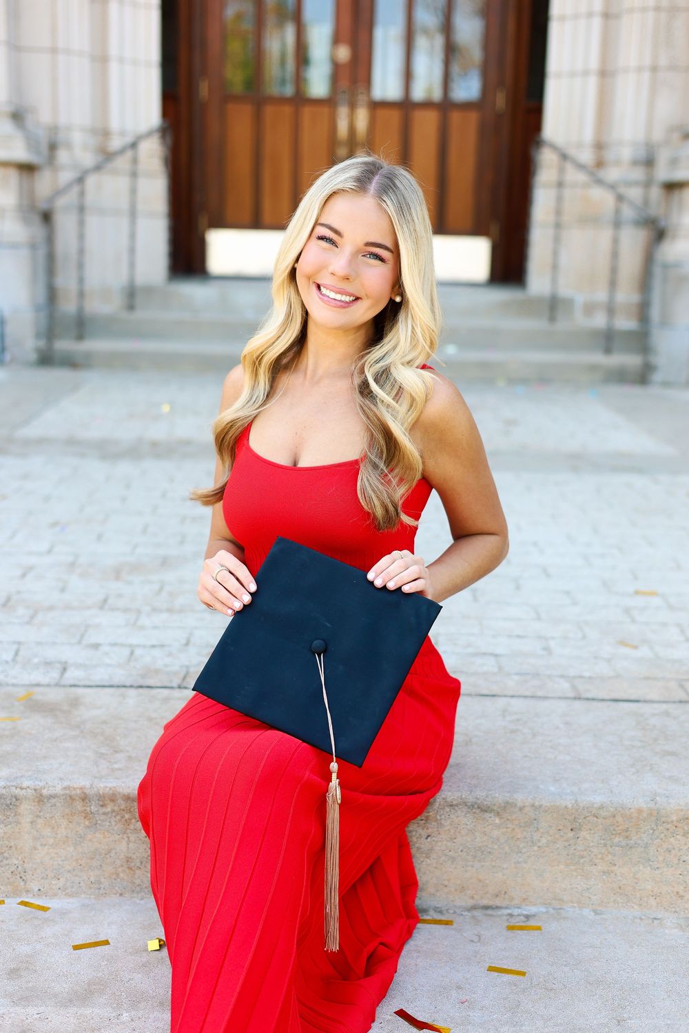 A series of four photos showing a person in a red and navy dress posing outdoors against a stone building backdrop.