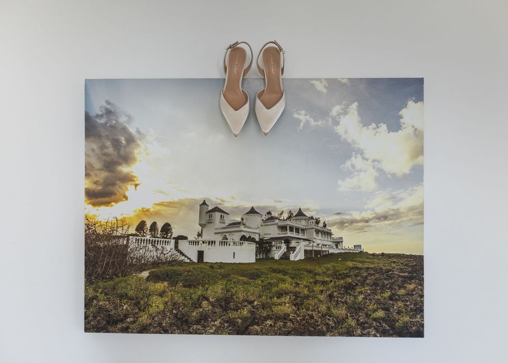 A collection of panoramic landscape photographs arranged in a row showing rural scenes and buildings at sunset.