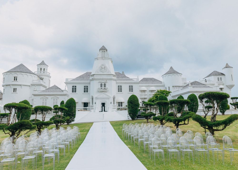 White church building with steeple sits atop a hill surrounded by rows of military cemetery headstones.