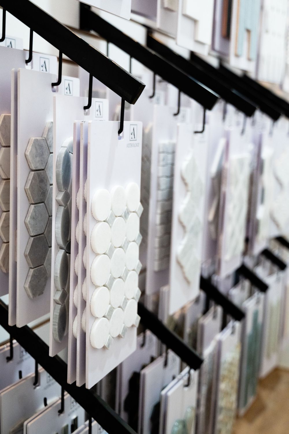 Row of angled white hexagonal wall decorations creating a modern geometric pattern in an interior space.