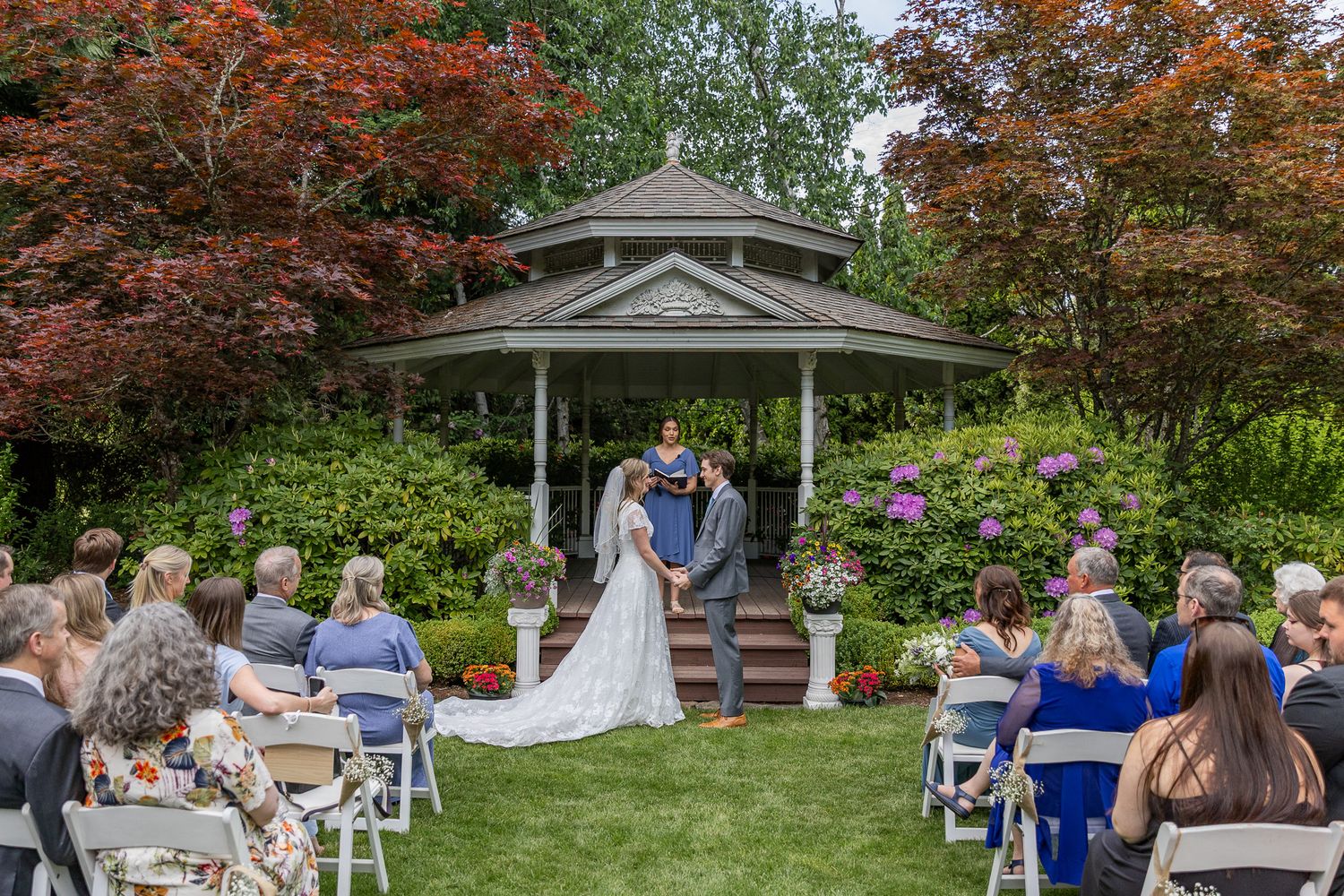 Bride and groom at the alter during their ceremony at Ogren Gardens in Eugene, Oregon, Captured by Oregon wedding photographer.
