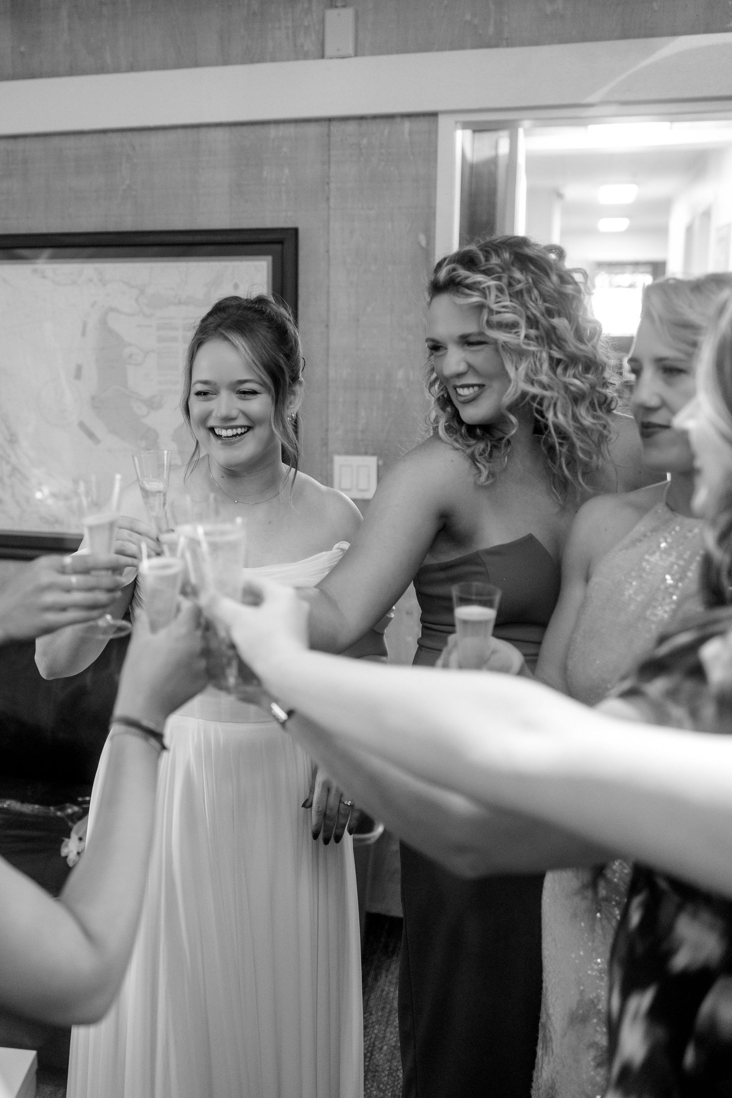 Wedding party members raise glasses in a celebratory toast during the reception.