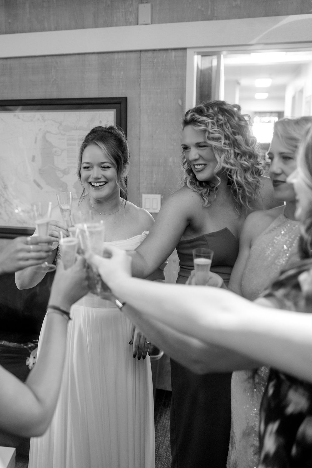 Wedding party members raise glasses in a celebratory toast during the reception.