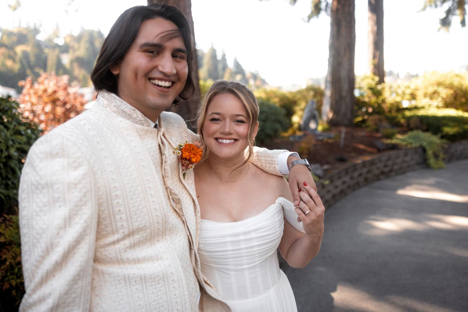 Couple shares joyful moment together during outdoor autumn wedding celebration.
