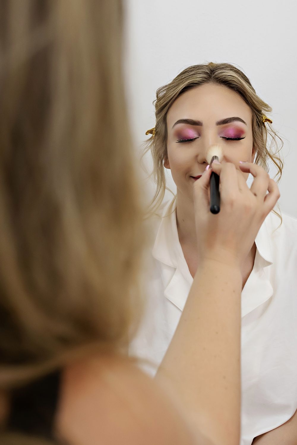 Bride getting her makeup done during getting ready at The Fives in Playa del Carmen.