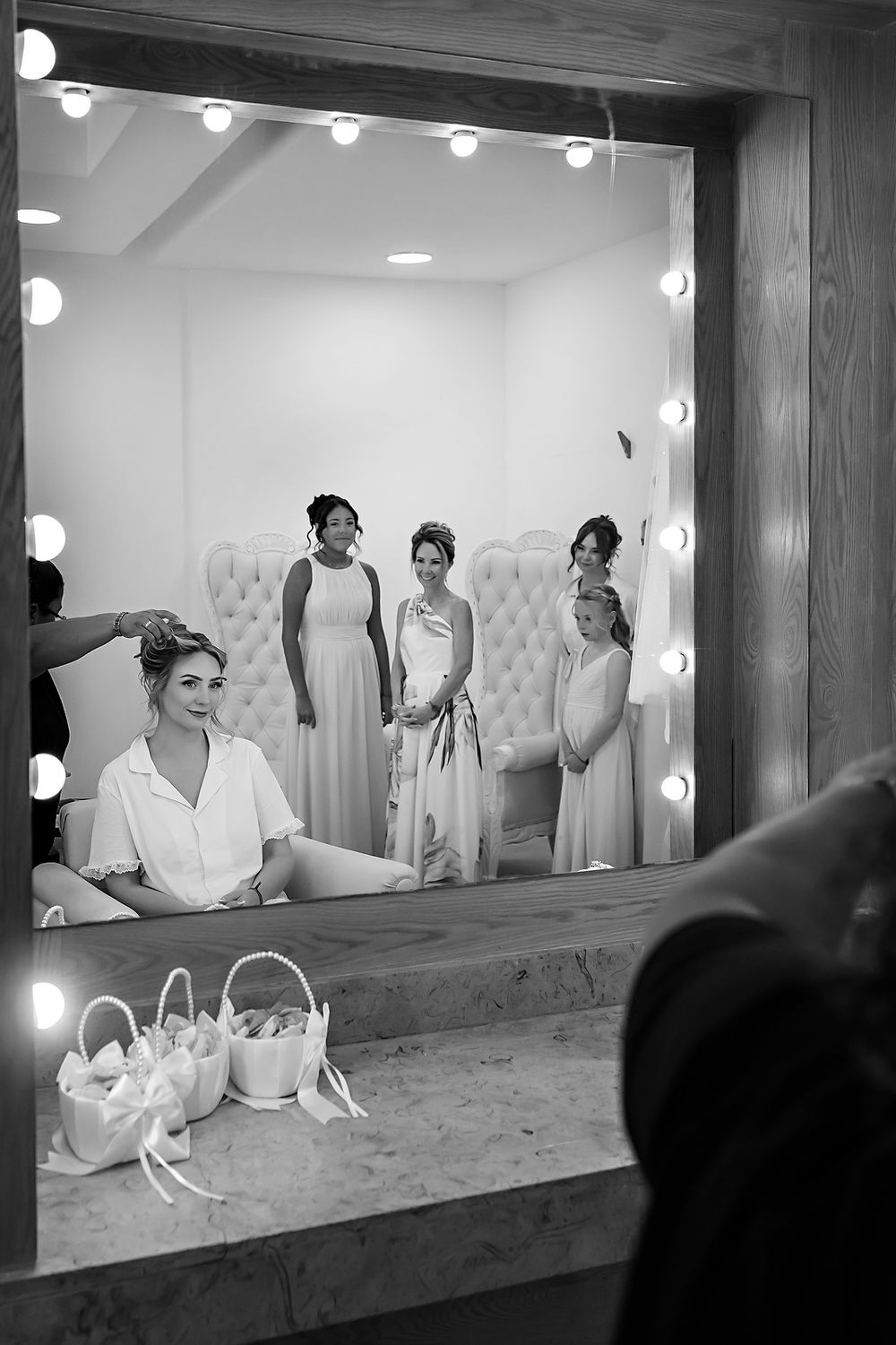 Bride and bridesmaids getting ready in mirror reflection at The Fives.