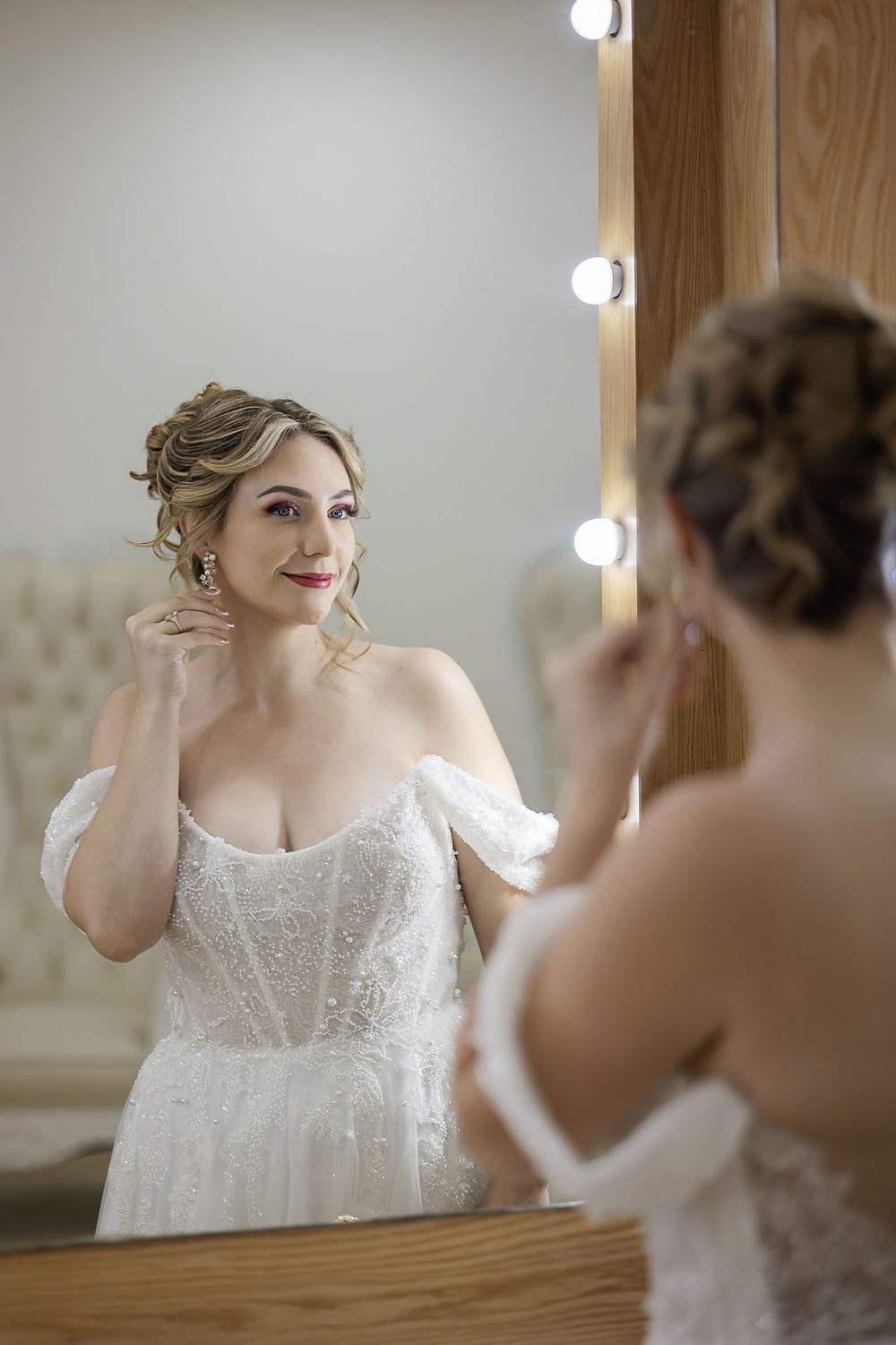 Bride looking at herself in the mirror before the ceremony at The Fives.