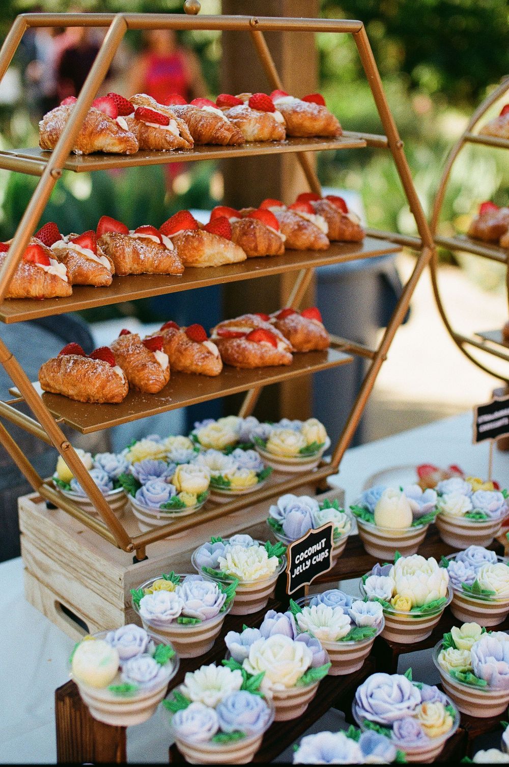 A close-up film photograph of the dessert table featuring mini cupcakes at a local Orange County wedding.