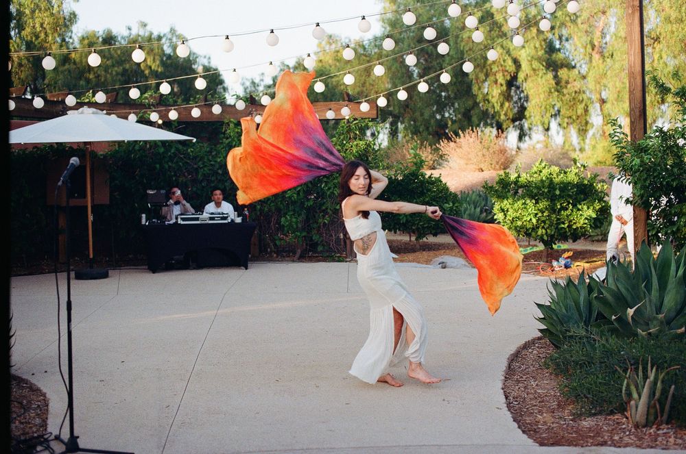 Orange County film photographer documenting traditional cultural dancers during a wedding reception celebration.