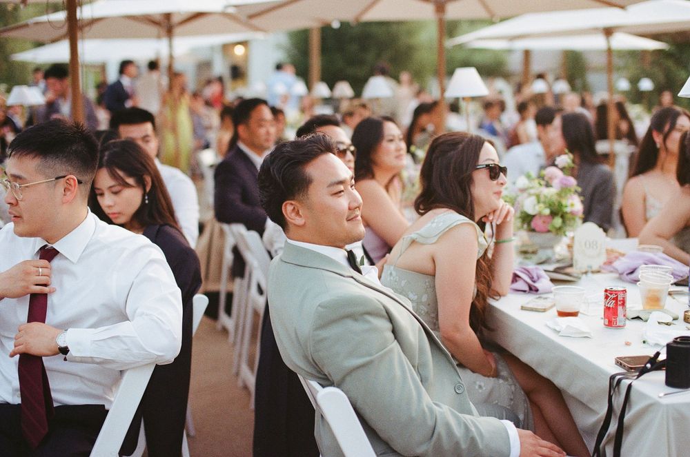 Wedding guests gathered around to watch the performers during a vibrant Orange County film photography session.