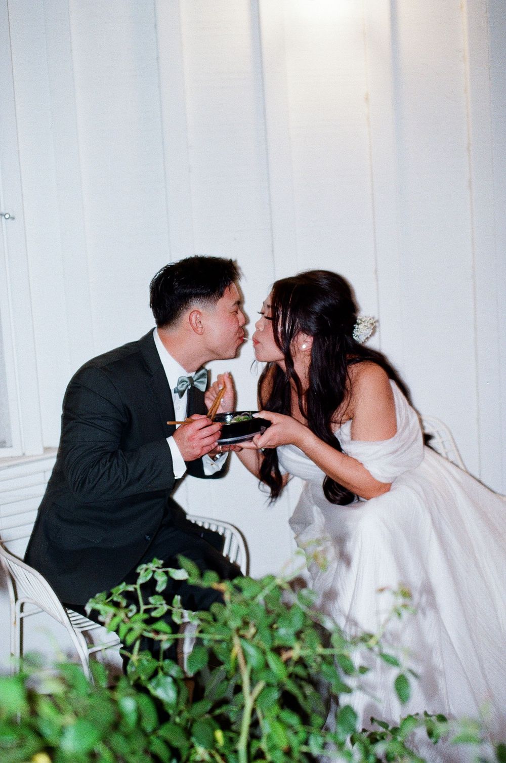 Orange County film photographer captures the unique moment of the bride and groom sharing a bowl of Pho during their reception.