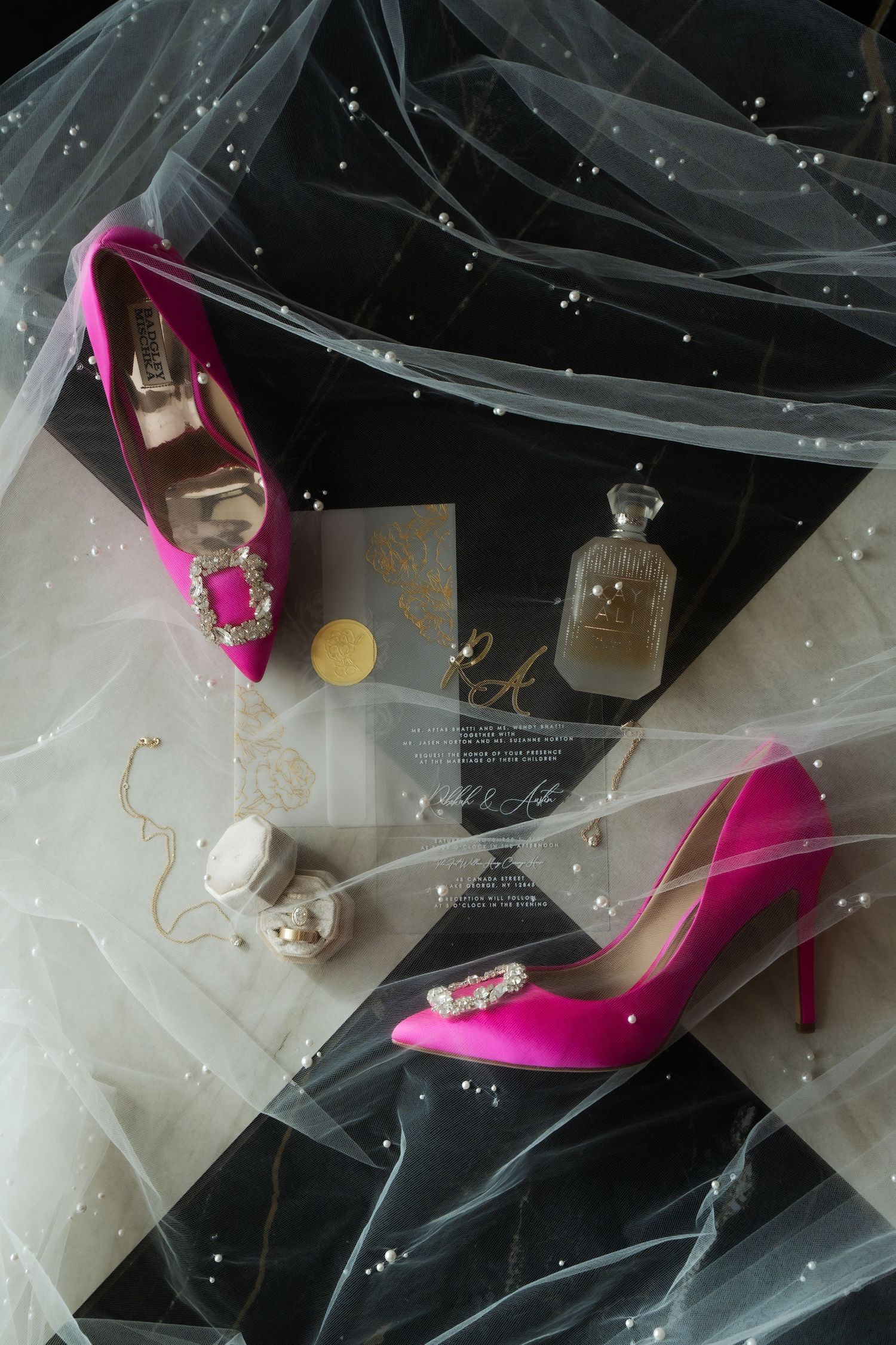 Hot pink bridal heels with veil details on a dark background.