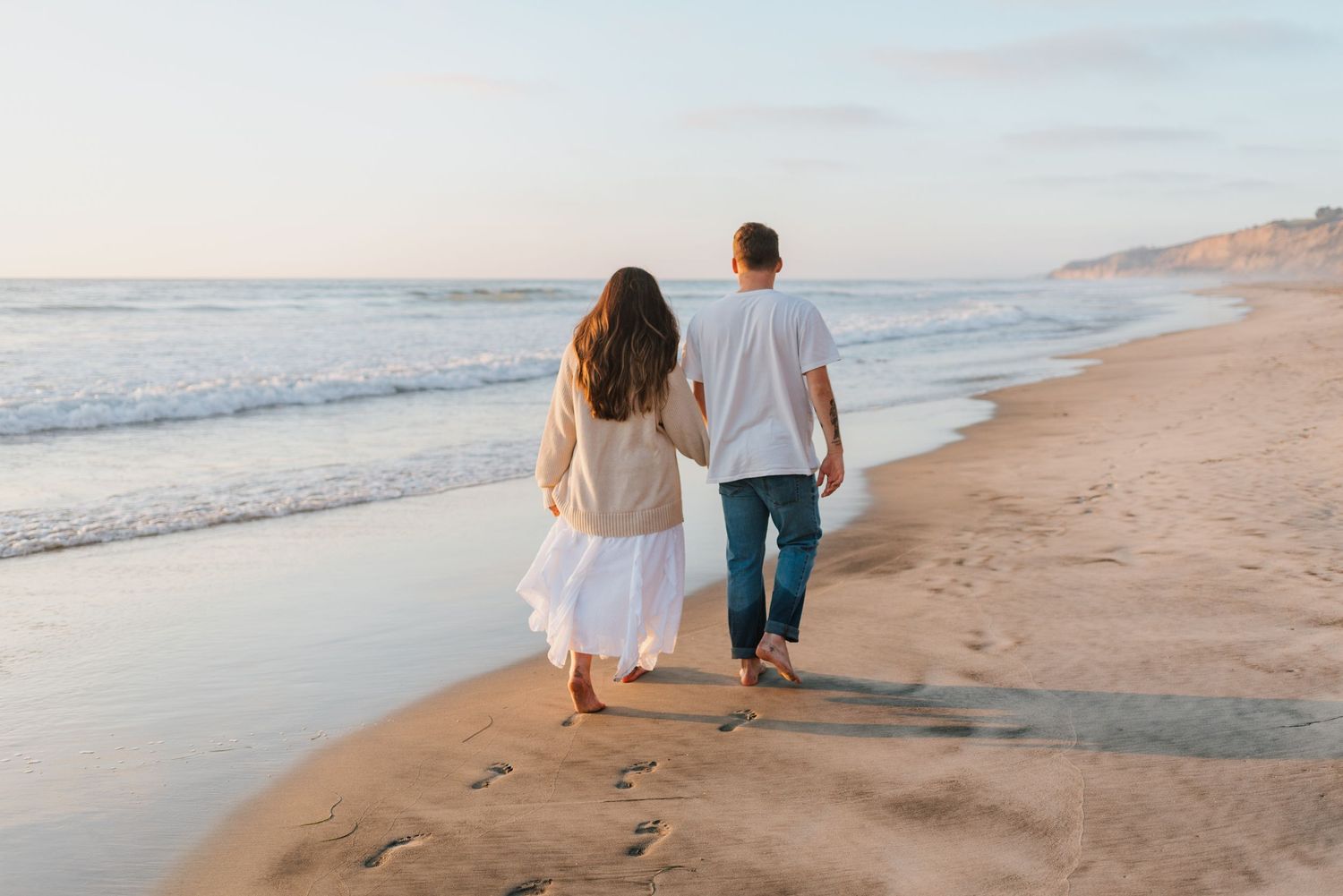 Blacks Beach couples photos with candid movement and dramatic coastal views, San Diego Engagement Photos