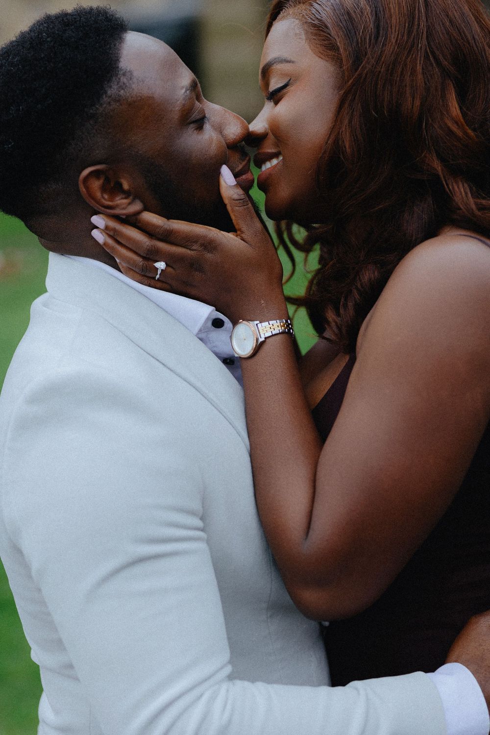 A romantic couple embraces closely while sharing tender moments outdoors.