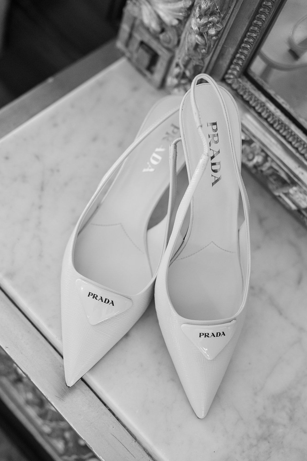 Elegant black and white Prada high heels with tulle fabric creating a dreamy, ethereal effect.