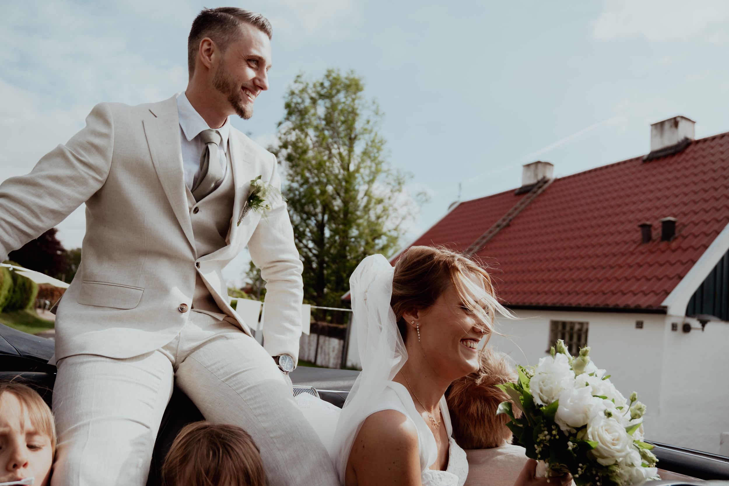 Close-up shots of a bride and groom in elegant wedding attire with white floral bouquet details.