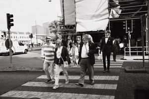 A collection of black and white street photography images showing urban life and pedestrians on city sidewalks.