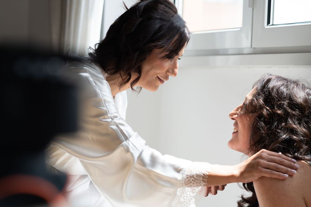 Tender moments captured in natural light during wedding preparations.